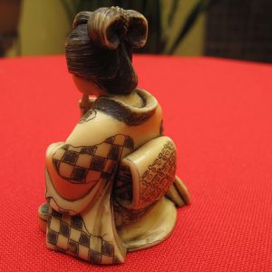 Antique carved japanese ivory Netsuke of a woman smoking his pipe