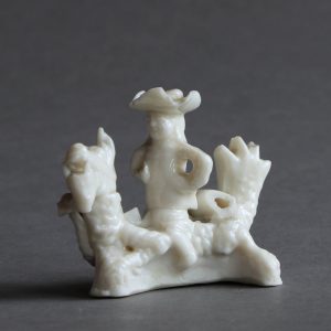 A miniature blanc de Chine whistle modelled as a European man on a dragon